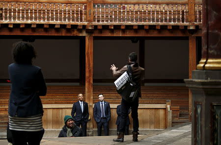 U.S. President Barack Obama watches a selection of songs and excerpts from Hamlet as he tours the Globe Theatre in London to mark the 400th anniversary of William Shakespeare's death April 23, 2016. REUTERS/Kevin Lamarque