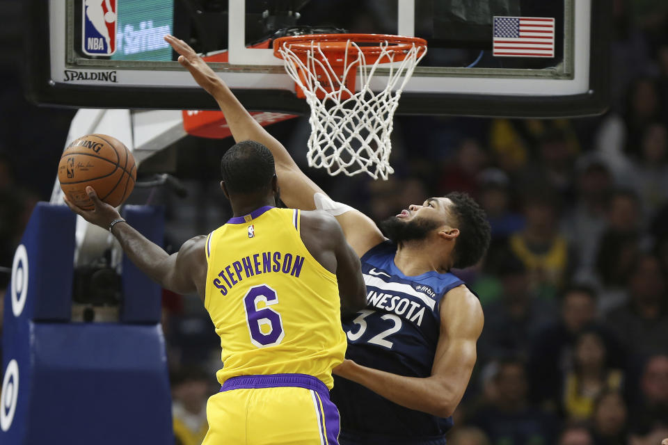 Los Angeles Lakers' Lance Stephenson tries to make a basket over Minnesota Timberwolves' Karl-Anthony Towns in the first half of an NBA basketball game Sunday, Jan. 6, 2019, in Minneapolis. (AP Photo/Stacy Bengs)