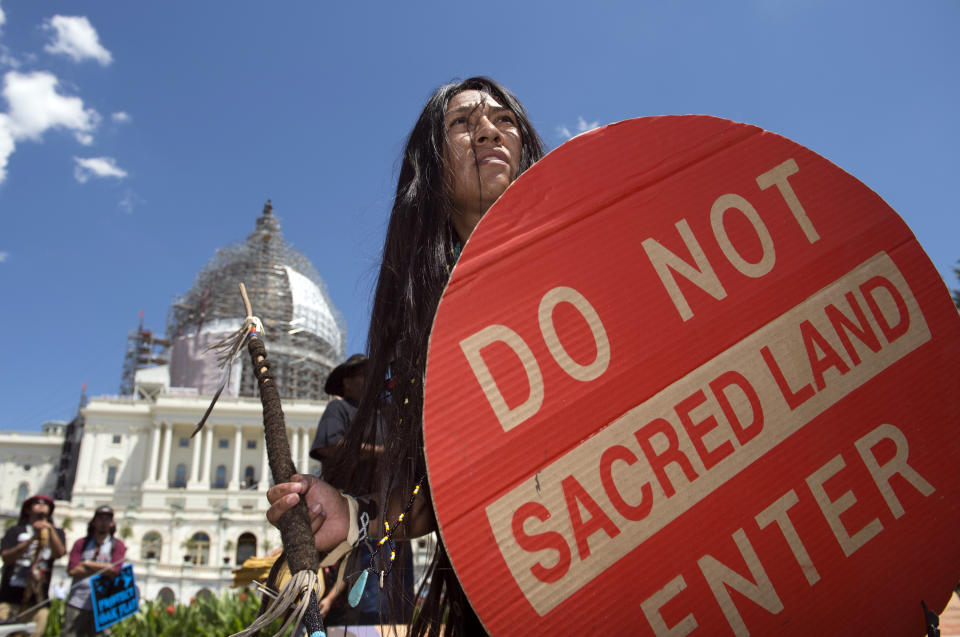 FILE - An Apache activist dancer performs in a rally to save Oak Flat, land near Superior, Ariz., sacred to Western Apache tribes, in front of the U.S. Capitol in Washington, Tuesday, July 22, 2015. An Apache group that has fought to protect land it considers sacred from a copper mining project in central Arizona suffered a significant blow Friday, March 1, 2024, when a divided federal court panel voted 6-5 to uphold a lower court's denial of a preliminary injunction to halt transfer of land for the project. (AP Photo/Molly Riley, File)