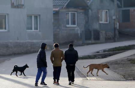 Roma men walk through a street past refurbished houses near the so called "Sheffield Square" in the town of Bystrany, Slovakia, November 28, 2016. REUTERS/David W Cerny