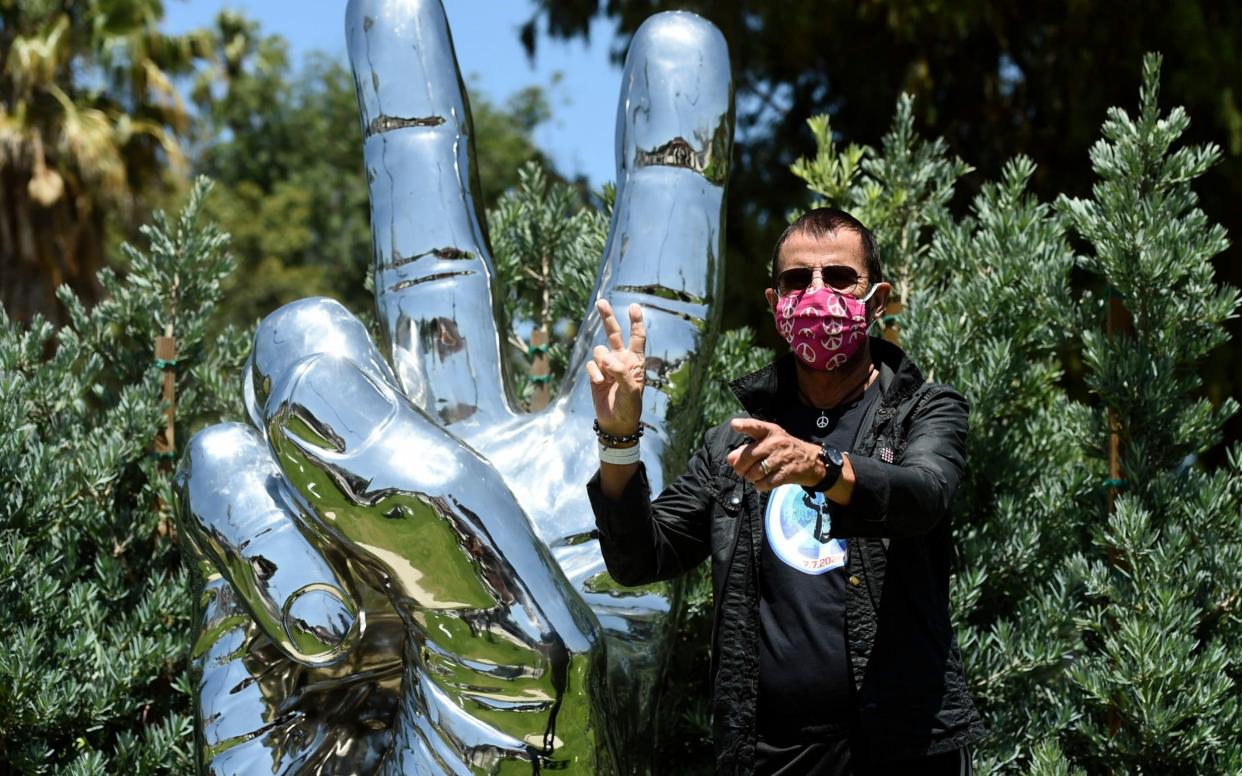 Ringo Starr poses in front of his 'Peace and Love'' sculpture on his 80th birthday - Invision
