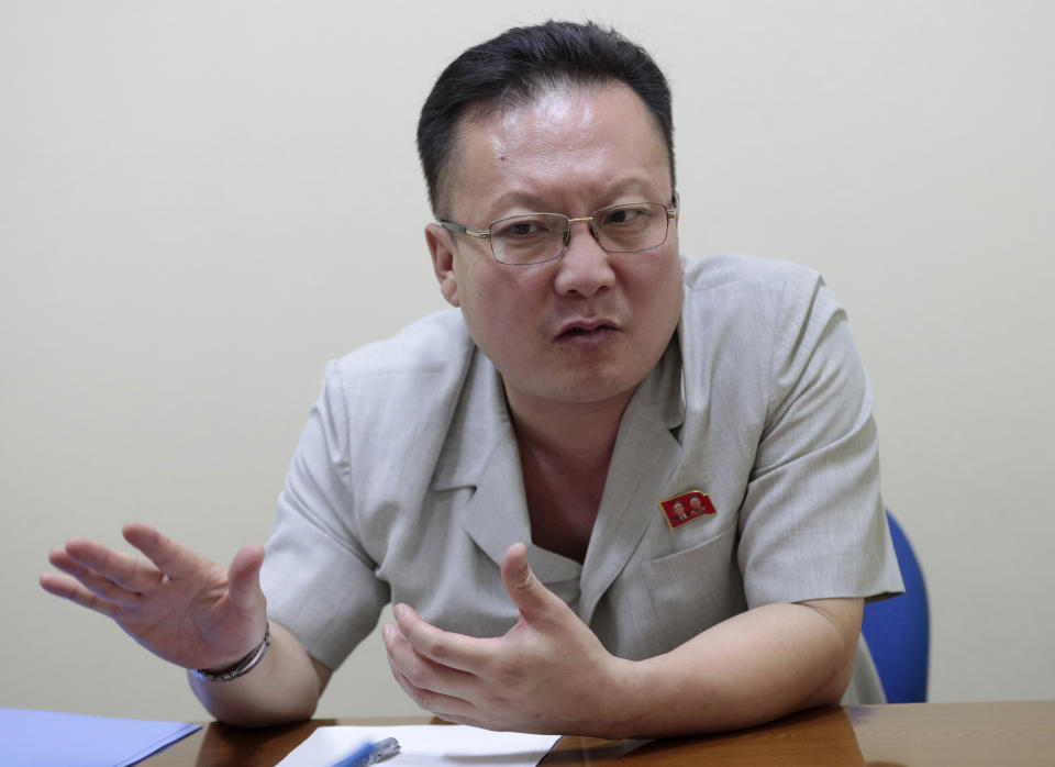 In this Sept. 12, 2019, photo, Kim Chang Kyong, Juche expert who is also the head of North Korean Social Scientists Association, speaks during an interview with The Associated Press in Pyongyang, North Korea. It's just a single word, but it's hard to miss in North Korea: Splashed across countless propaganda signs, seeded through dozens of state media reports, at the beating heart of emotional pop songs and on the lips of the earnest guides who show off the grand monuments built in its honor. The word is Juche, and while it's technically a political ideology, in its difficulty for many outsiders to grasp, its ability to inspire devotion among North Koreans, and its ubiquity as a symbol of state power, it can seem more like a religion. (AP Photo/Dita Alangkara)