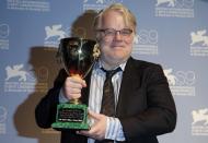U.S. actor Philip Seymour Hoffman holds the Coppa Volpi for the Best Actor in the movie "The Master" at the 69th Venice Film Festival in Venice in this September 8, 2012, file photo. Award-winning actor Philip Seymour Hoffman was found dead in his apartment in New York City on Sunday, the Wall Street Journal reported, citing a law-enforcement official, February 2, 2014. REUTERS/Tony Gentile/Files (ITALY - Tags: ENTERTAINMENT OBITUARY)