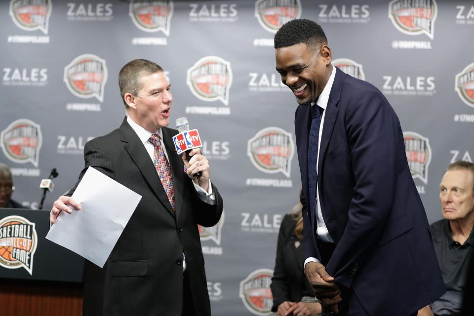 Chris Webber, right, has a complicated relationship with the University of Michigan, but he was quick to accept an invitation from Jim Harbaugh to be an honorary captain. (Photo by Ronald Martinez/Getty Images)