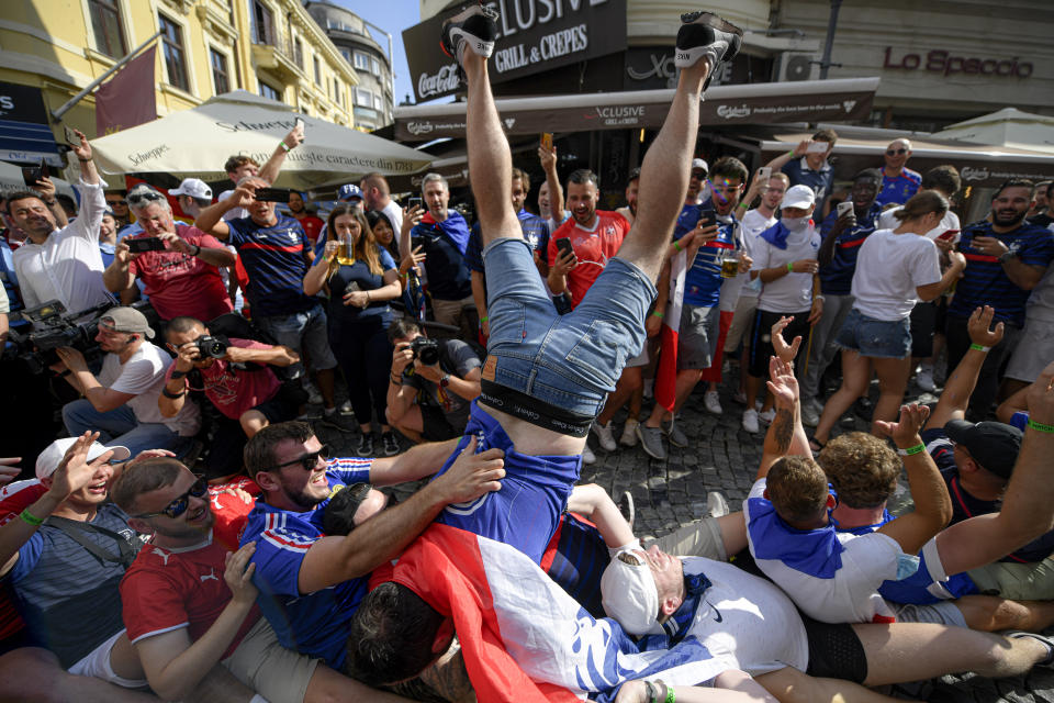 FILE - In this June 28, 2021, file photo, France's fans cheer prior to the Euro 2020 soccer championship round of 16 match between France and Switzerland in the old city district of Bucharest, Romania. Countries across Europe are scrambling to accelerate coronavirus vaccinations to outpace the spread of the delta variant in a high-stakes race to prevent hospital wards from filling up again with patients fighting for their lives. (AP Photo/Andreea Alexandru, File)