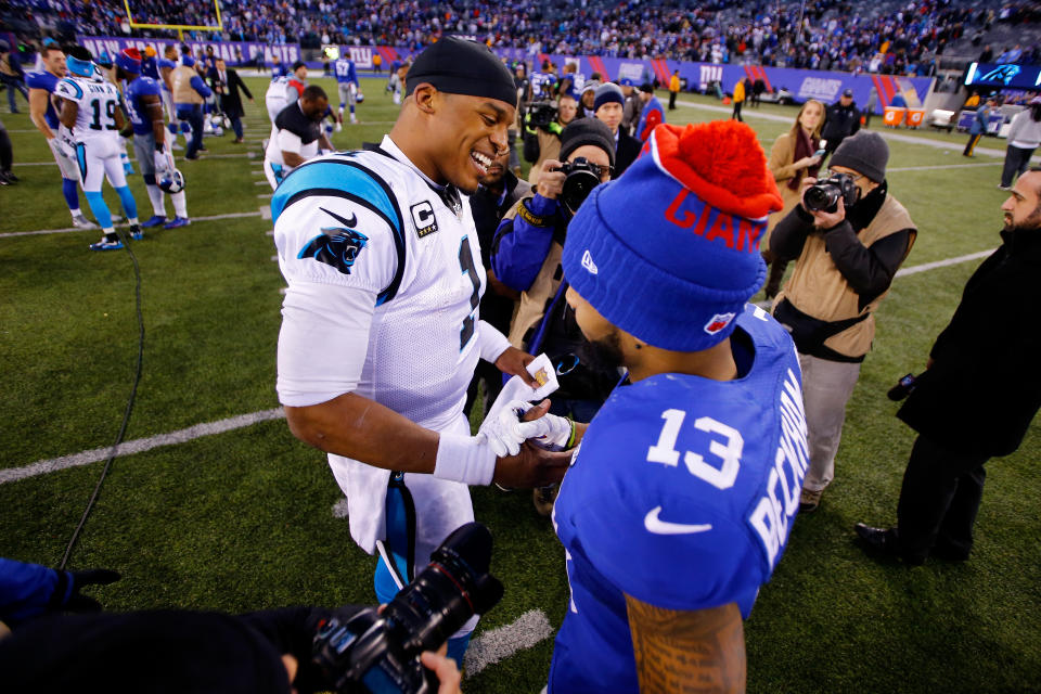 Cam Newton, left, and then-Giants receiver Odell Beckham, right, share a postgame handshake in 2015. (Photo by Michael Reaves/Getty Images)