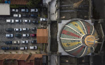 Parishioners stay in their cars during a drive-in Sunday Mass set up by Father Jonathan Gonzalez to circumvent the regulations that prevent concentrations in religious temples, imposed since March by the authorities to curb the spread of the new coronavirus, at the parking lot of the "Nuestra Señora de Coromoto" church in the El Paraiso neighborhood of Caracas, Venezuela, Sunday, Oct. 25, 2020. (AP Photo/Matias Delacroix)