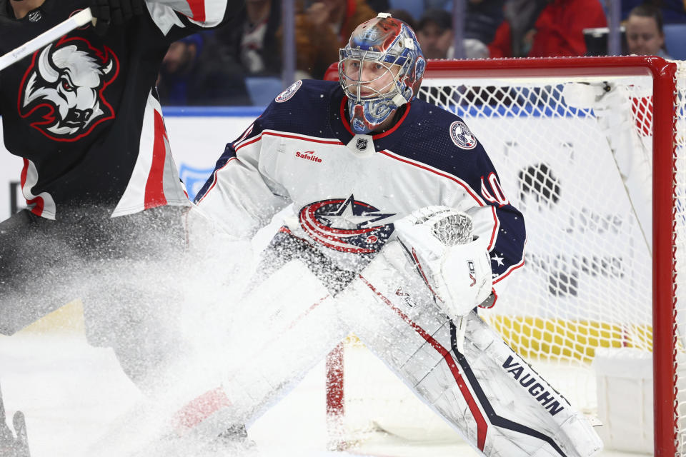 Colorado Avalanche goaltender Alexandar Georgiev (40) looks for the puck in traffic during the first period of the team's NHL hockey game against the Buffalo Sabres on Tuesday, Dec. 19, 2023, in Buffalo, N.Y. (AP Photo/Jeffrey T. Barnes)