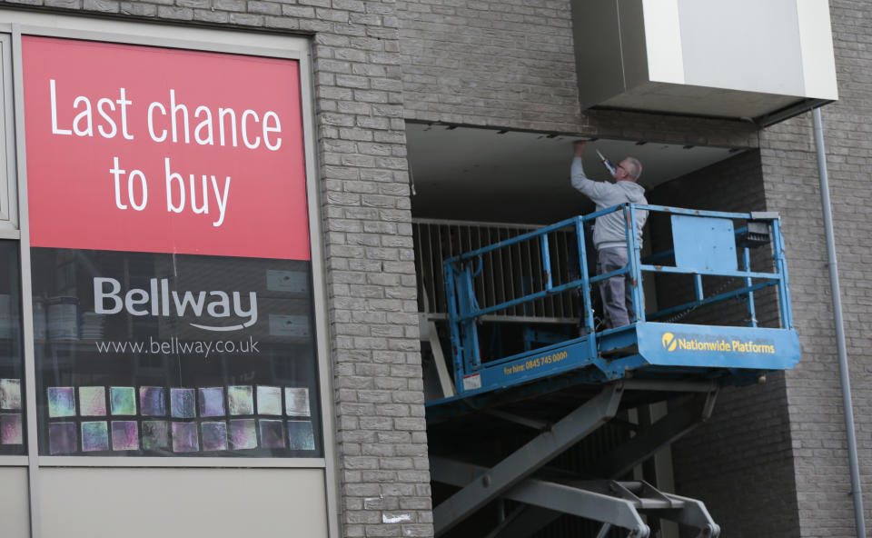 A man works at a Bellway housing development in London, Britain October 12, 2015. British housebuilder Bellway Plc said it would increase its output by as much as 10 percent this year after it sold a  record 7,752 homes in the 12 months to end-July, helping pretax profit rise 44 percent. Photograph taken October 12, 2015. REUTERS/Suzanne Plunkett