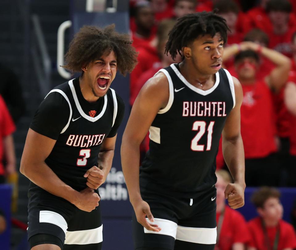 Buchtel guard Amire Robinson, left, celebrates as the Griffins increase their lead over Lutheran West during the second half of the OHSAA Division II state final, Sunday, March 19, 2023, in Dayton.