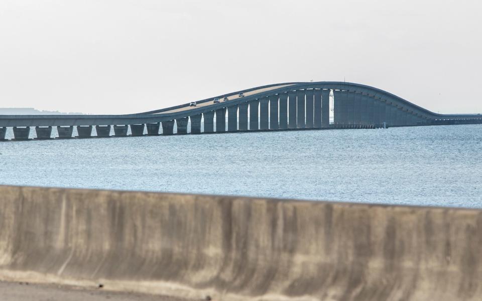 Vehicles make their way over the Garcon Point Bridge toll plaza in Santa Rosa County on May 4. The Florida Department of Transportation has agreed to pay $134 million to take control of the bridge.