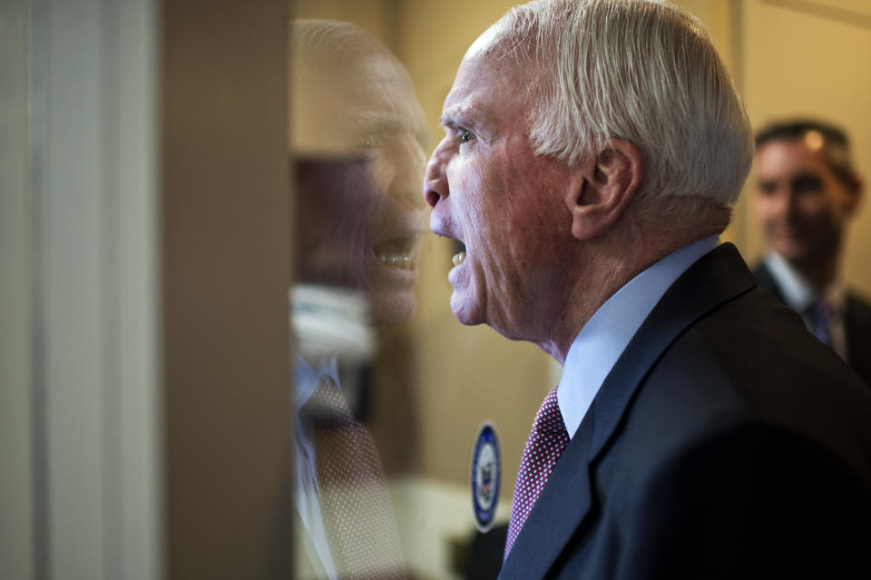 Sen. John McCain (R-Ariz.) fools around with colleagues upon arriving for a news conference on Guantanamo detainees in the Senate studio on Jan. 13, 2015.