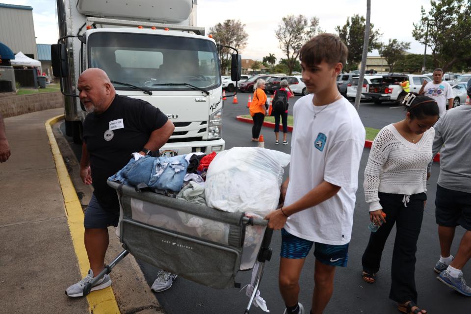Volunteers with King's Cathedral Maui unload a donation of clothing on August 10, 2023 in Kahului, Hawaii.