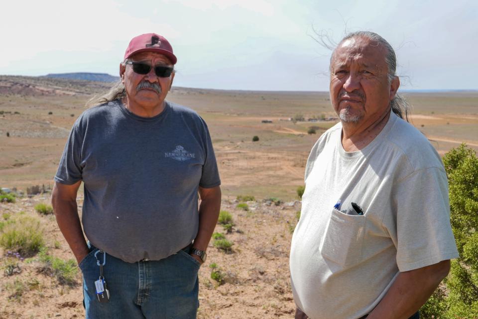 Henry Tso and Arnold Slowman, a local leader in the Tolikan chapter — a town-like designation within Navajo Nation — stand on a hilltop overlooking the reservation in Tse Tah, Arizona.