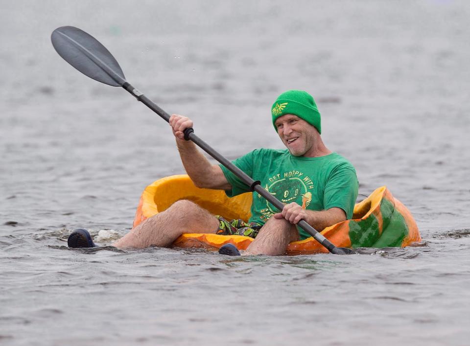 Dr. Kier Stewart, a Halifax cardiac surgeon, displays his technique as he races his giant pumpkin in the 19th annual Windsor-West Hants Pumpkin Festival regatta on Lake Pisiquid in Windsor, N.S., on Sunday, October 15, 2017. Participants hollow out the massive gourds and pilot them across the 800 metre course. THE CANADIAN PRESS/Andrew Vaughan