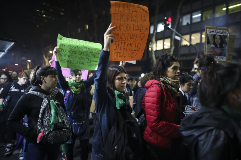 A woman holds up a sign that reads in Spanish "They'll never have the comfort of our silence again" during a protest against gender violence in Buenos Aires, Argentina, Monday, June 3, 2019. The grassroots movement "Ni una menos," or Not One Less, is marking its fourth anniversary by remembering the hundreds of women who have been murdered since its founding, and demanding laws to curb gender based violence that continues to permeate Argentine society. (AP Photo/Natacha Pisarenko)