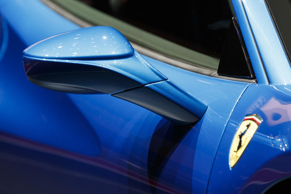 CAPTION CORRECTS CAR NAME A door mirror of the new 'Ferrari F8 Tributo' is pictured during the press day at the '89th Geneva International Motor Show' in Geneva, Switzerland, Tuesday, March 05, 2019. The 'Geneva International Motor Show' takes place in Switzerland from March 7 until March 17, 2019. Automakers are rolling out new electric and hybrid models at the show as they get ready to meet tougher emissions requirements in Europe - while not forgetting the profitable and popular SUVs and SUV-like crossovers. (Cyril Zingaro/Keystone via AP)