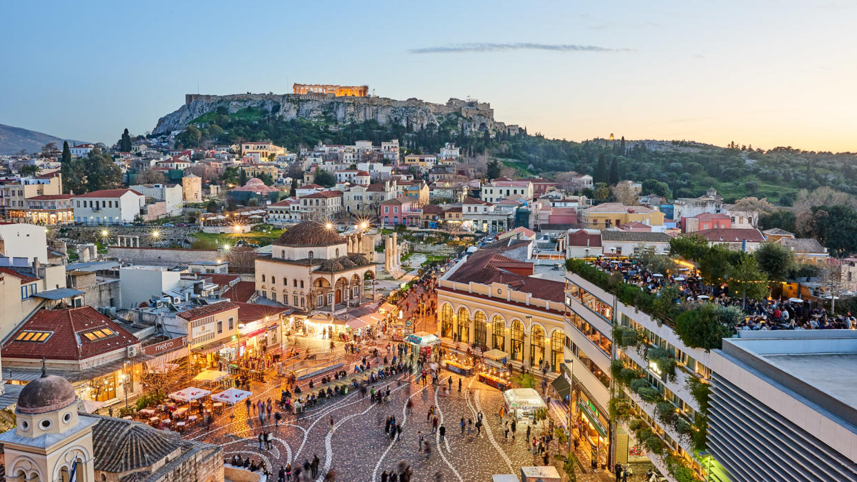 Athens, Greece - February 13, 2016: Aerial view of Athens at sunset with an illuminated Acropolis in the background.