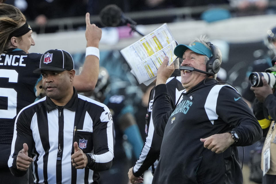 Jacksonville Jaguars Doug Pederson celebrates with Jacksonville Jaguars quarterback Trevor Lawrence (16) after a win in overtime against the Dallas Cowboys after an NFL football game, Sunday, Dec. 18, 2022, in Jacksonville, Fla. (AP Photo/John Raoux)