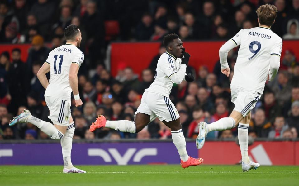 Wilfried Gnonto of Leeds United celebrates after scoring the team's first goal with teammates during the Premier League match between Manchester United and Leeds United - Michael Regan/Getty Images