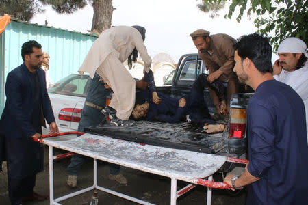 People carry an injured man to a hospital after a blast in Khost province, Afghanistan May 6, 2018. REUTERS/Stringer