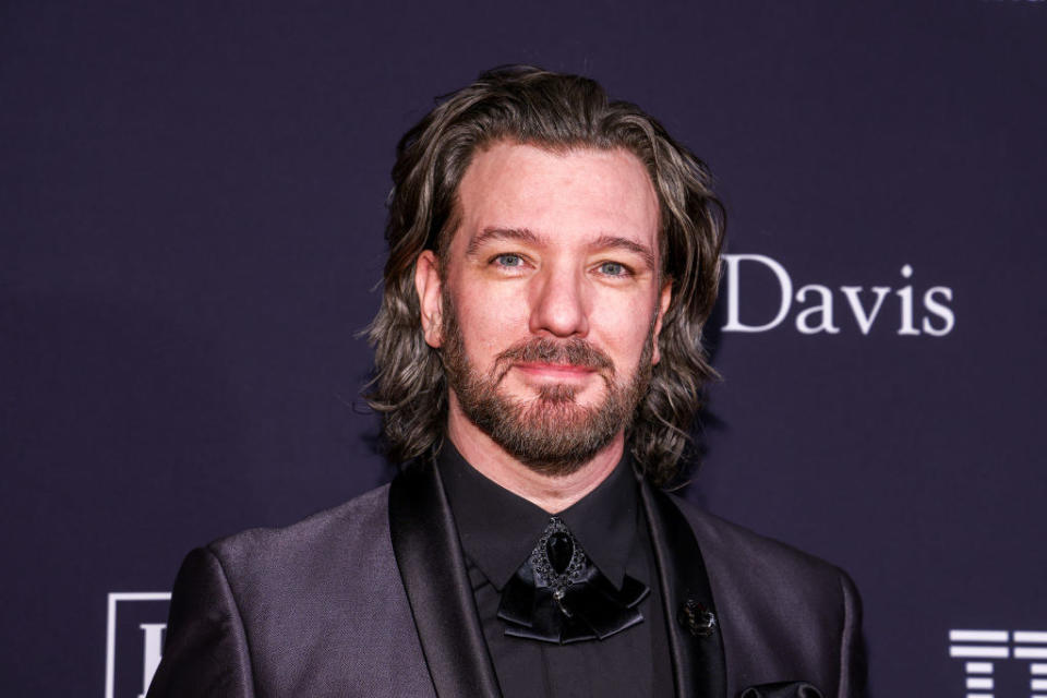 A closeup of a bearded JC at a red carpet event