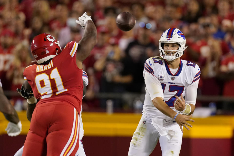 Buffalo Bills quarterback Josh Allen (17) throws over Kansas City Chiefs defensive tackle Derrick Nnadi (91) during the first half of an NFL football game Sunday, Oct. 10, 2021, in Kansas City, Mo. (AP Photo/Charlie Riedel)