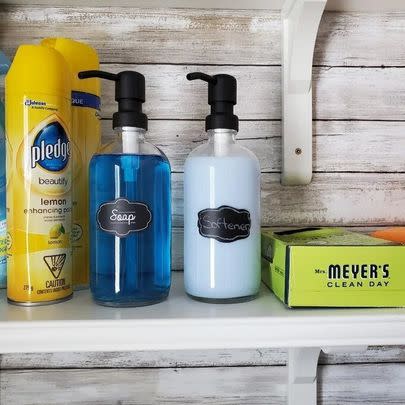 A pair of matching glass soap and lotion dispensers