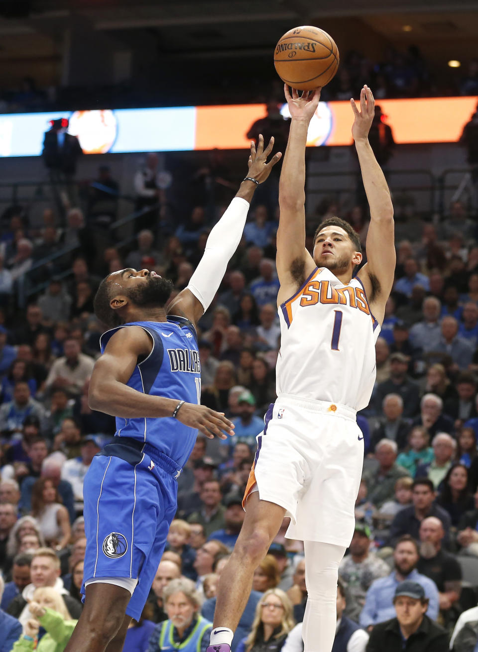 Phoenix Suns guard Devin Booker (1) shoots over Dallas Mavericks guard Tim Hardaway Jr. (11) during the first half of an NBA basketball game Tuesday, Jan. 28, 2020, in Dallas. Phoenix won 133-104. (AP Photo/Ron Jenkins)