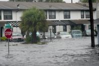 Vehicles sit in floodwaters on Sept. 29 outside the Palm Isle Apartments in Orlando following Hurricane Ian.