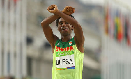 FILE PHOTO: 2016 Rio Olympics - Athletics - Final - Men's Marathon - Sambodromo - Rio de Janeiro, Brazil - 21/08/2016. Feyisa Lilesa (ETH) of Ethiopia celebrates. REUTERS/Athit Perawongmetha Picture Supplied by Action Images/File Photo