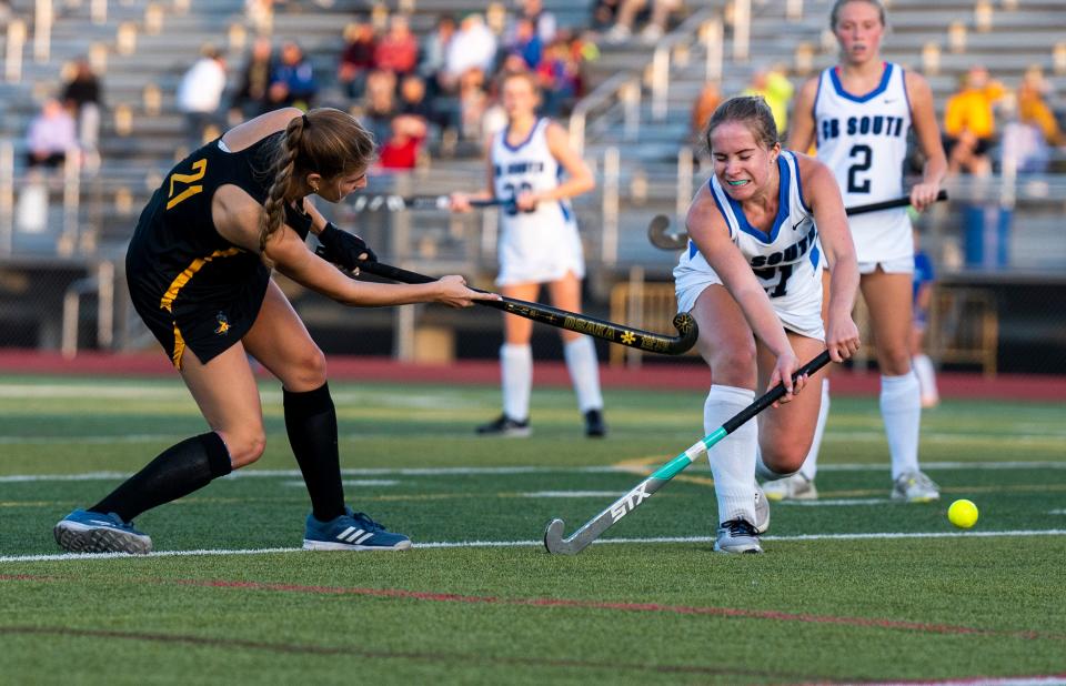 Central Bucks West's Eve Damsker (21) against Central Bucks South's Kaitlin Sullivan (21) during their field hockey game at Central Bucks South High School in Warrington on Wednesday, Oct. 11, 2023.

[Daniella Heminghaus| Bucks County Courier Times]]