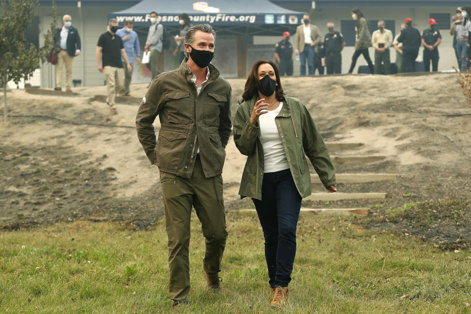 California Gov. Gavin Newsom and Democratic vice presidential candidate Sen. Kamala Harris, D-Calif., talk as they asses the damage during the Creek Fire at Pine Ridge Elementary, Tuesday, Sept. 15, 2020, in Auberry, Calif. (AP Photo/Gary Kazanjian)