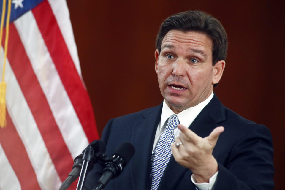 FILE - Florida Gov. Ron DeSantis answers questions from the media in the Florida Cabinet following his State of the State address during a joint session of the Senate and House of Representatives, Tuesday, March 7, 2023, at the state Capitol in Tallahassee, Fla. Texas and Florida are being led by tough-talking Republican governors weighing presidential runs as their state lawmakers debate especially strict legislation on border security. (AP Photo/Phil Sears, File)