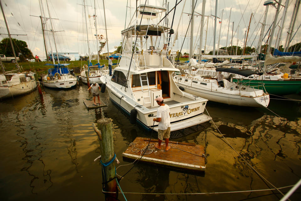 <p>Mariners work together to secure each other’s vessels at Harbor Square Marina as residents in the area prepare ahead of Hurricane Irma on September 07, 2017 in Meritt Island, Fla. (Photo: Brian Blanco/Getty Images) </p>