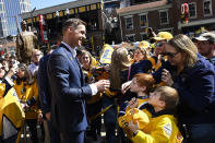 Former Nashville Predators goaltender Pekka Rinne, left, greets fans during the unveiling ceremony of his statue before an NHL hockey game between the Nashville Predators and the Seattle Kraken, Saturday, March 25, 2023, in Nashville, Tenn. (AP Photo/Mark Zaleski)