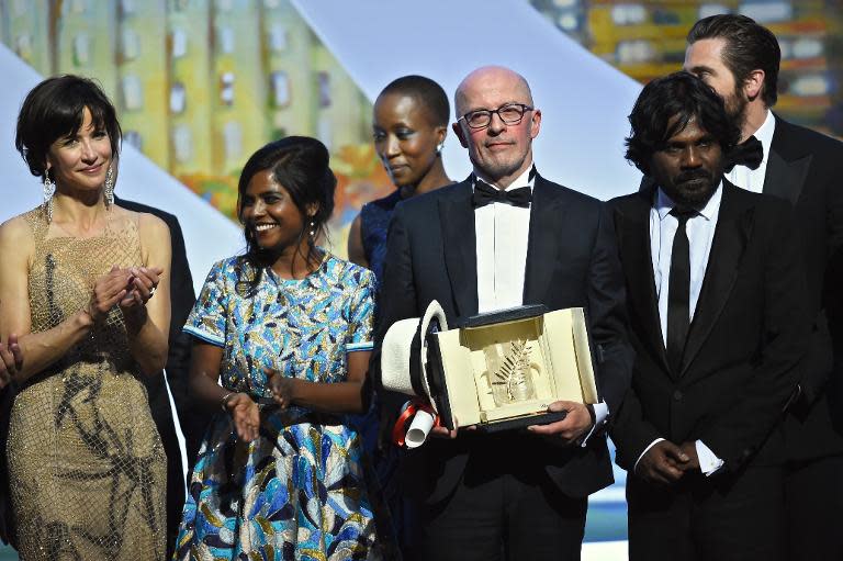 French director Jacques Audiard (C) with stars of his Palme d'Or winning film "Dheepan", Sri Lankan actress Kalieaswari Srinivasan (2ndL) and Sri Lankan actor Jesuthasan Antonythasan