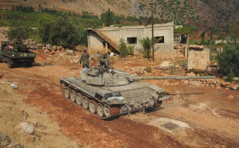 A handout picture released by the official Syrian Arab News Agency (SANA), shows Syrian army units and pro-government forces deploying at an undisclosed location in western Syria on October 8, 2015