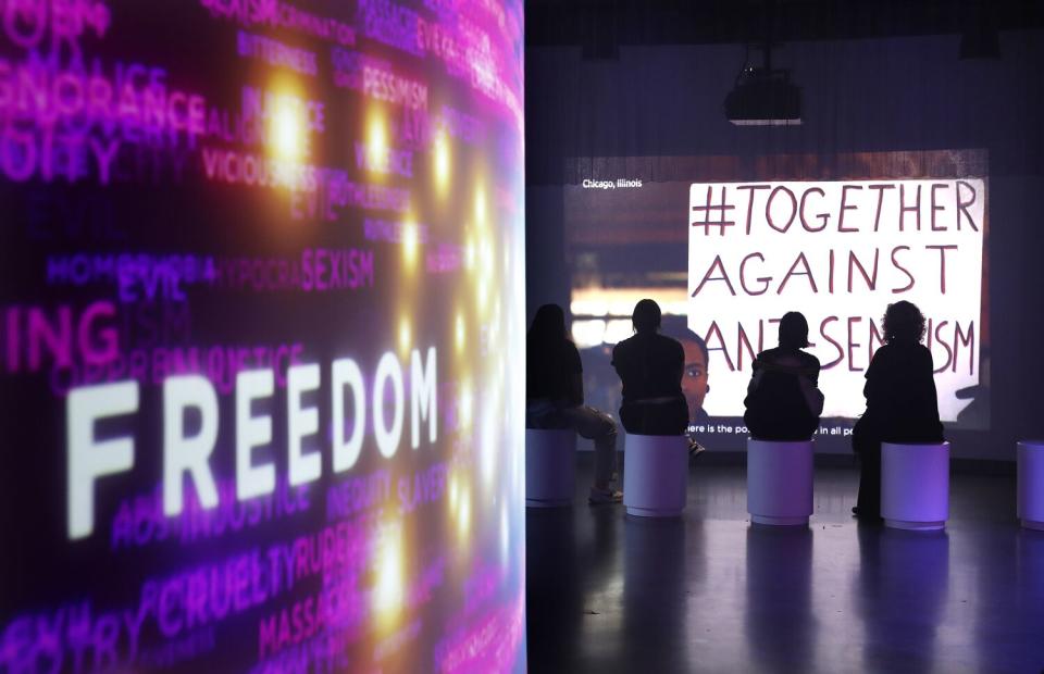 Visitors at the Museum of Tolerance in Los Angeles watch a video presentation at the end of their tour.