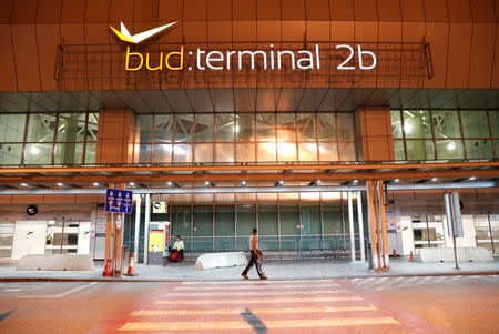 A man walks in front of Budapest Airport's terminal 2B, Hungary, August 15, 2018 after one terminal of the airport and its surroundings were briefly shut down as the Disaster Management Authority ordered an investigation due to an overheated container carrying an isotope on an incoming flight. REUTERS/Bernadett Szabo