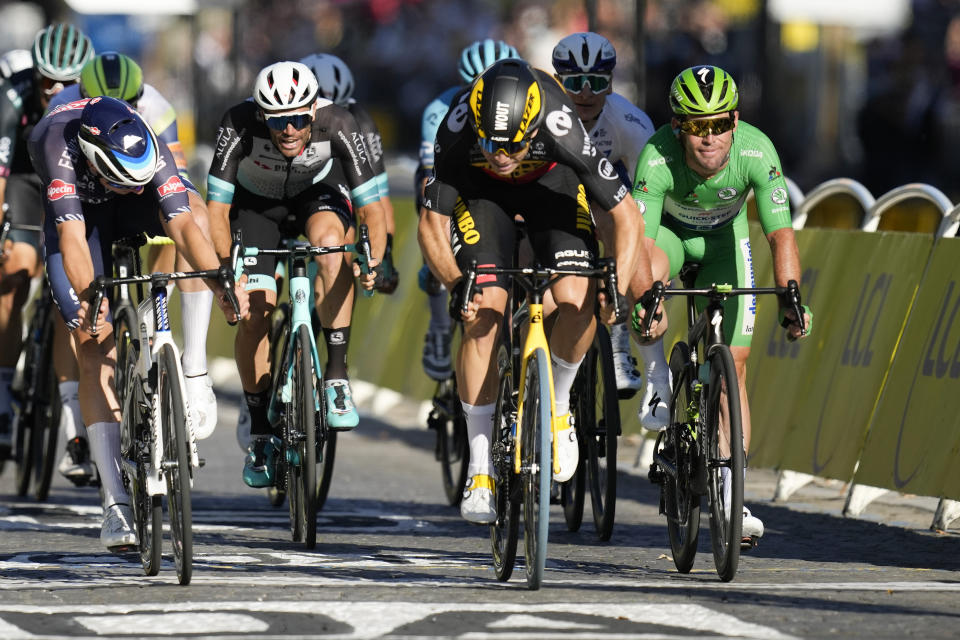 Britain's Mark Cavendish, wearing the best sprinter's green jersey, grimaces as Belgium's Wout Van Aert, center right, wins the sprint of the twenty-first and last stage of the Tour de France cycling race over 108.4 kilometers (67.4 miles) with start in Chatou and finish on the Champs Elysees in Paris, France,Sunday, July 18, 2021. (AP Photo/Christophe Ena)