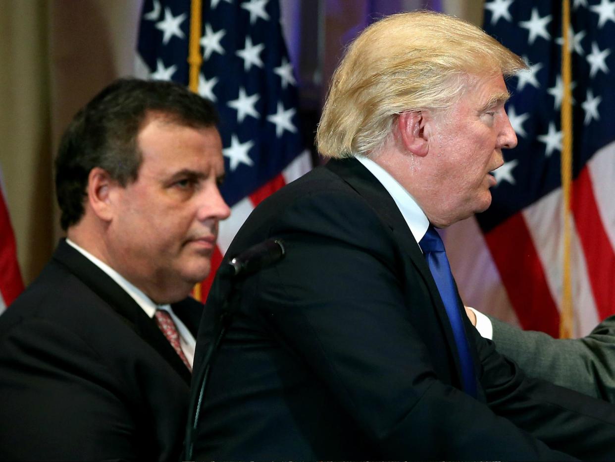 New Jersey Governor Chris Christie accompanies then-Republican Presidential frontrunner Donald Trump off the stage after a press conference on Super Tuesday, 1 March 2016 in Florida: John Moore/Getty Image