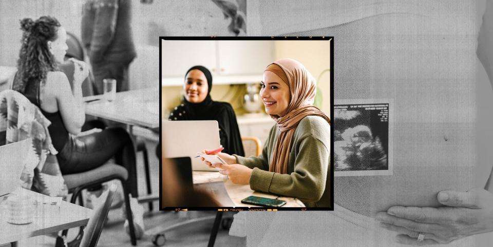 two women in headscarves sat at a table at some kind of workshop