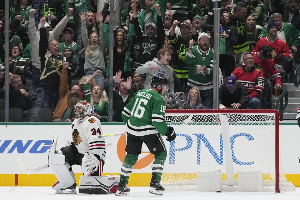 Chicago Blackhawks goaltender Petr Mrazek (34) and Dallas Stars center Joe Pavelski (16) look on after Stars' Roope Hintz (not shown) scored during the second period of an NHL hockey game in Dallas, Friday, Dec. 29, 2023. (AP Photo/LM Otero)