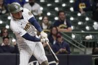 Milwaukee Brewers' Luis Urias hits an RBI single during the second inning of a baseball game against the Milwaukee Brewers Friday, May 14, 2021, in Milwaukee. (AP Photo/Morry Gash)