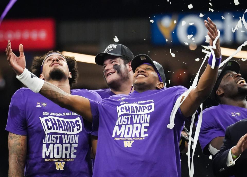 Washington Huskies quarterback Michael Penix Jr. (9), center, and his teammates watch as confetti begins to fall after winning the Sugar Bowl College Football Playoff semi-finals at the Ceasars Superdome in New Orleans, Louisiana, Jan. 1, 2024. The Huskies won the game over the Texas Longhorns 37-31.