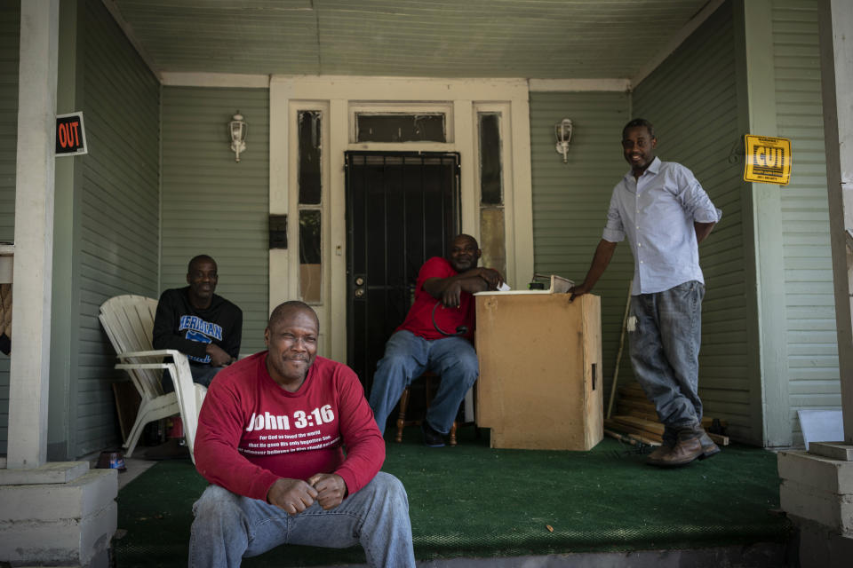 Pictured from left to right, Gregory Blanchard, 53, Clyde Lewis, 59, Tommy McCoy, 48 and Anthony Boggan, 49, pose for a group portrait on McCoy's front porch, in Meridian, Miss., on Tuesday, Oct. 6, 2020. Distrust of the government runs deep in the Black community in Mississippi, where harsh voter suppression tactics - voting fees, tests on the state constitution, even guessing the number of beans in a jar - kept all but about 6% of Black residents from voting into the 1960s. Boggan sometimes votes, but is sitting it out this year, disgusted at the choices. “They’re all going to tell you the same thing,” he said. “Anything to get elected.” (AP Photo/Wong Maye-E)