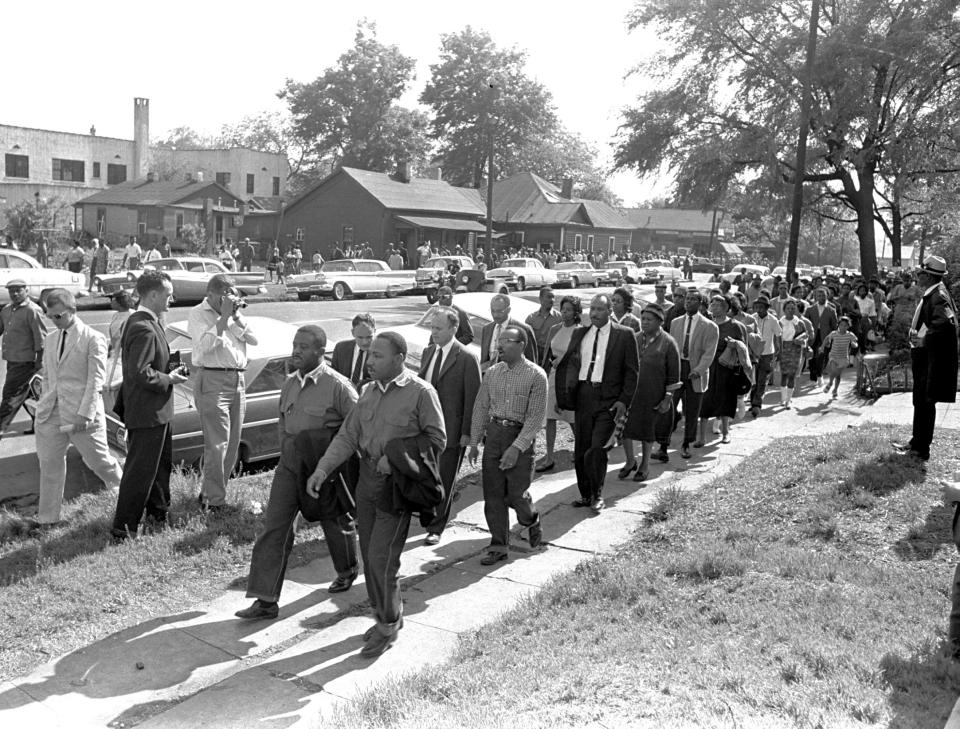 The Rev. Ralph Abernathy, left, and the Rev. Martin Luther King Jr. lead a column of demonstrators as they attempt to march on Birmingham, Ala., city hall April 12, 1963. Police intercepted the group short of their goal.