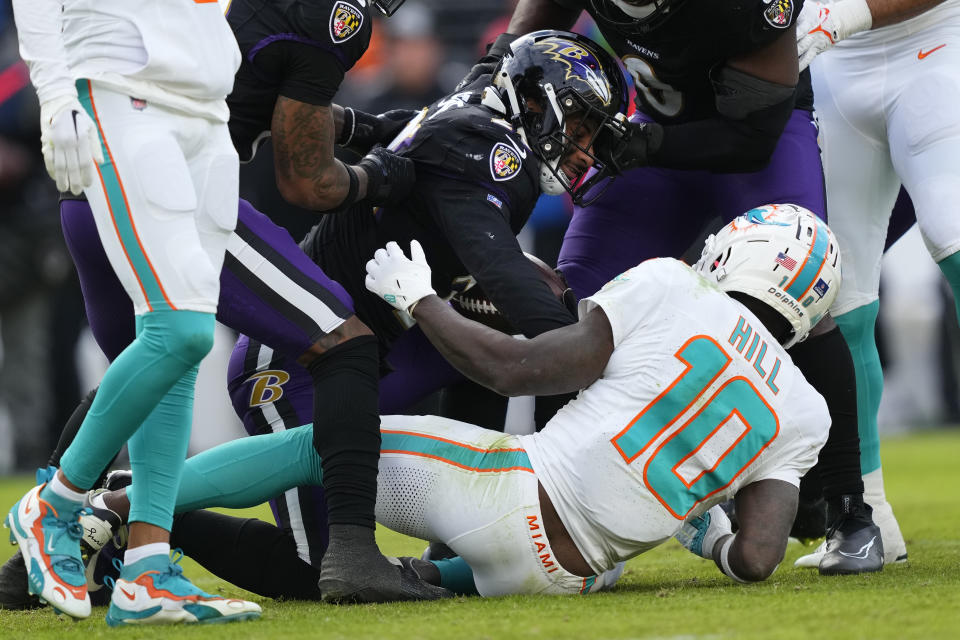 Baltimore Ravens safety Geno Stone (26) gets up after intercepting a pass intended for Miami Dolphins wide receiver Tyreek Hill (10) during the second half of an NFL football game in Baltimore, Sunday, Dec. 31, 2023. (AP Photo/Matt Rourke)