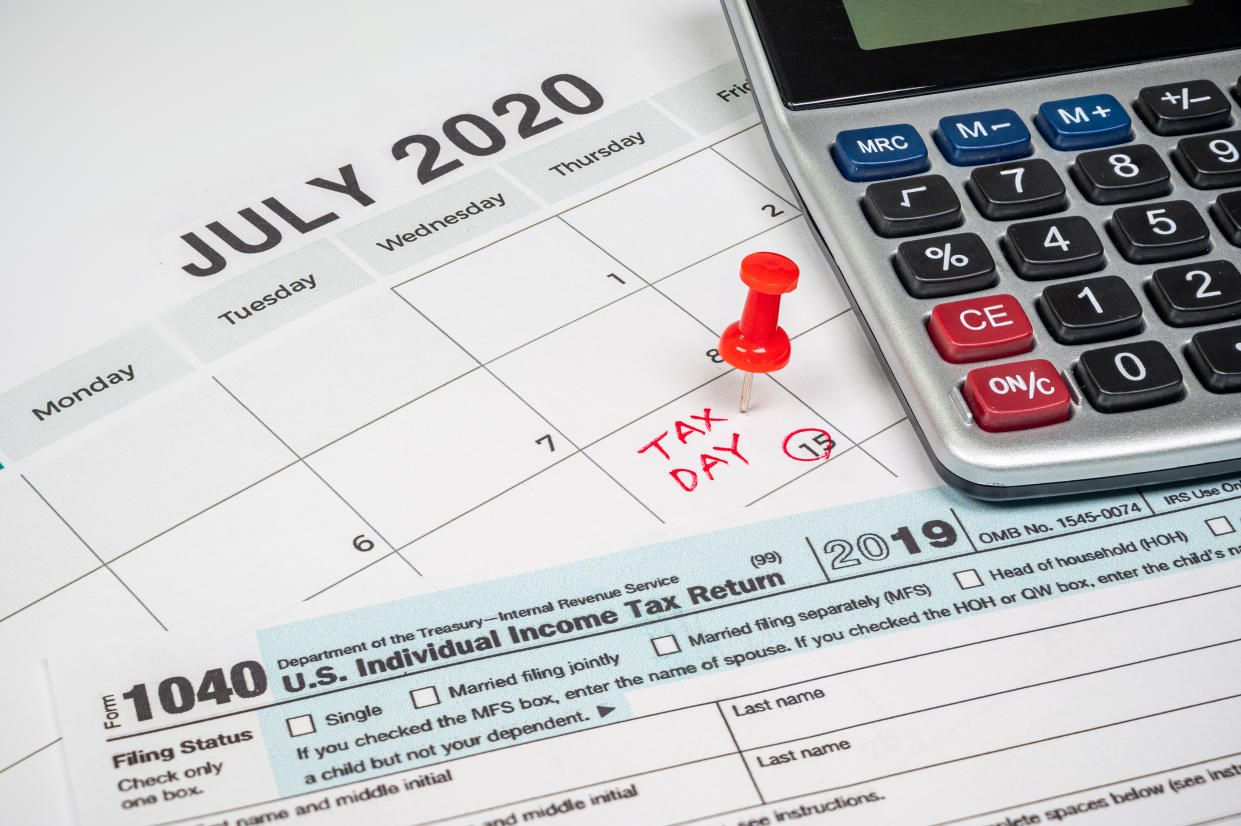 The tax day was extended to July 15th because of Covid-19. July calendar showing 1040 return form and tax day